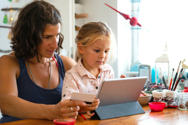 istock Mother paying with credit card from home 1178310558