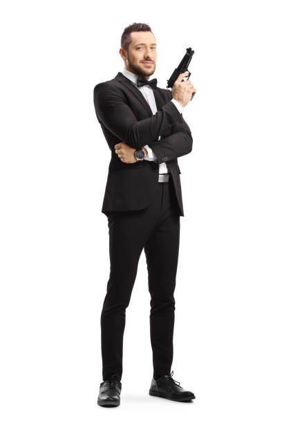 man in a suit holding a gun - gun men spy suit imagens e fotografias de stock