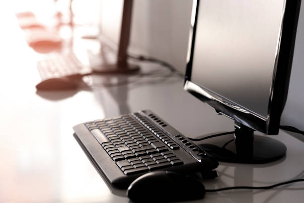 A working office. Study desk. Sequential computers on a desk. Keyboards and mice. And other computer parts. Selective focus available.Office, Desk, Computer Monitor, Computer, Desktop PCCable, Desk, Messy, Chaos, Computer Cable