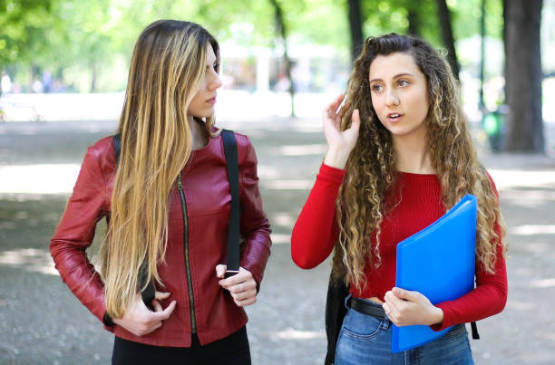 istock Two female schoolmates talking in a college courtyard 1178315513