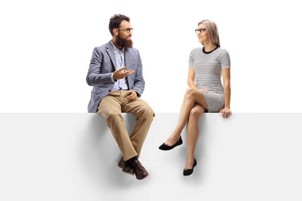 istock Bearded man talking to a blond woman seated on a panel 1178315931