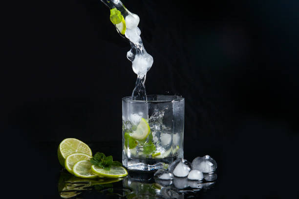 istock Summer cocktail mojito with splash on black background. 1178316445