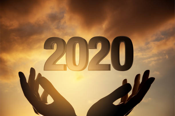 istock 2020 new year concept with silhouette hands against sunset 1178317610