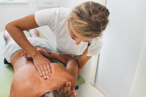istock Physio massaging a patient under her shoulder blade 1178317800