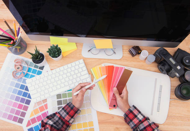 istock Graphic designer artist creative looking at colour chart at desk in office. 1178320422