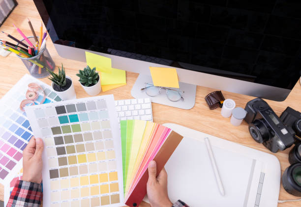 istock Graphic designer artist creative looking at colour chart at desk in office. 1178320432