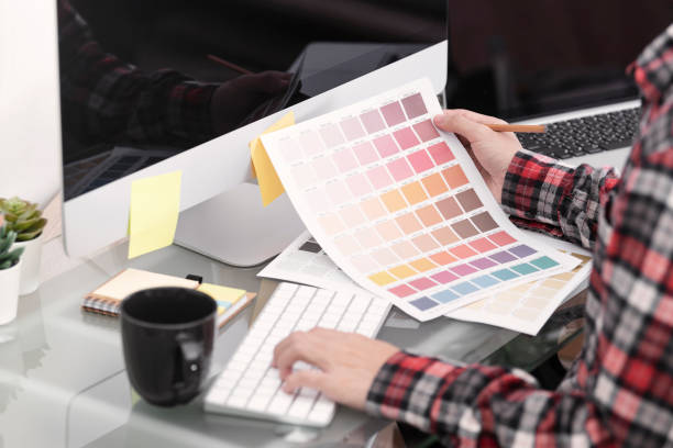 istock Graphic designer artist creative looking at colour chart at desk in office. 1178320451