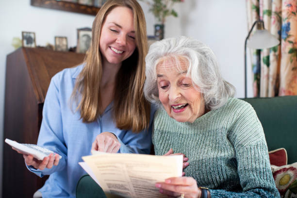 istock Woman Helping Senior Neighbor With Bills And Paperwork 1178321479