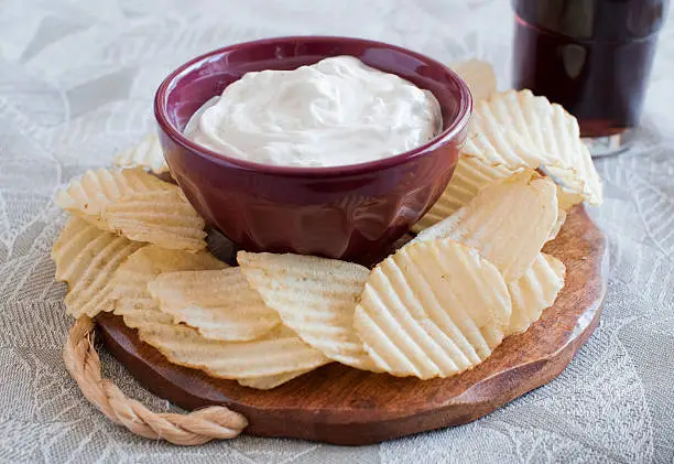 Photo of Plate of potato chips and dip with a soda