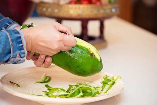Natural fresh lime and lime cut in half on cutting board. Fresh ripe green limes on wooden table.