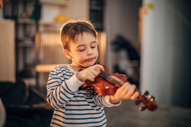 istock Little boy teaching to play violin 1178328946