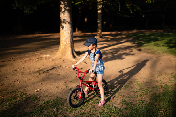 istock Girl riding a bicycle in the woods 1178330191