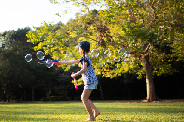 istock Girl playing with soap bubbles in autumn park 1178330210
