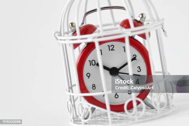 Closeup Of Red Alarm Clock In A Cage Concept Of Time Limit Stock Photo - Download Image Now