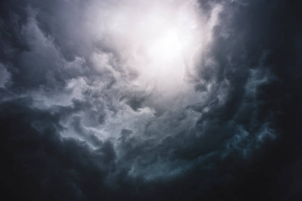 Dramatic Sky Bright Hole View on storm clouds from the ground, forming powerful thunderstorm. storm cloud stock pictures, royalty-free photos & images