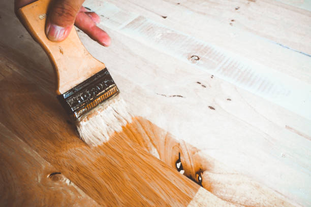 istock Applying varnish paint on a wooden surface 1178334805