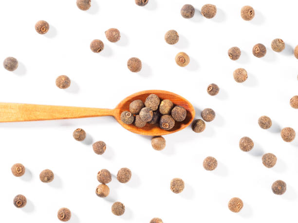 istock Allspice (Jamaica pepper) in the wooden spoon horizontally on white background 1178334835
