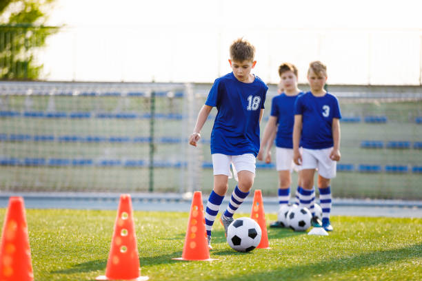 istock Boys on Sports Training. Football Training Dribbling Cone Drill 1178336586