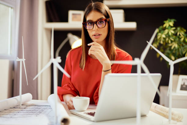 istock Buinesswoman holding coffee while sitting in office. 1178337596