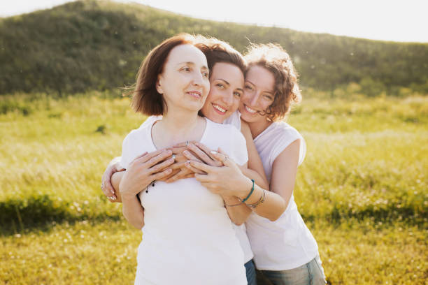 istock Two adult daughters hugging their mother 1178337773