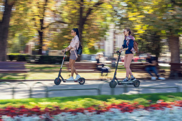 istock Girlfriends commuting in the city on electric scooters 1178338224