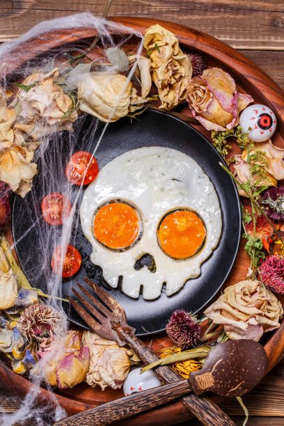 istock Fried eggs in the shape of a skull and fresh tomatoes. 1178338554