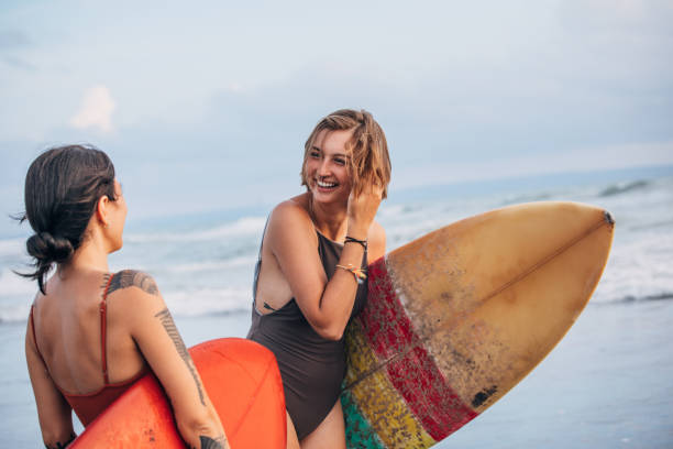 istock Woman surfers at the beach 1178339164