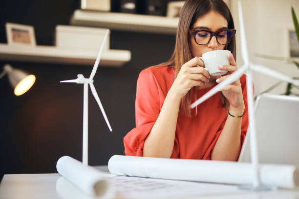 istock Businesswoman drinking coffee in office. Sustainable development concept. 1178339194