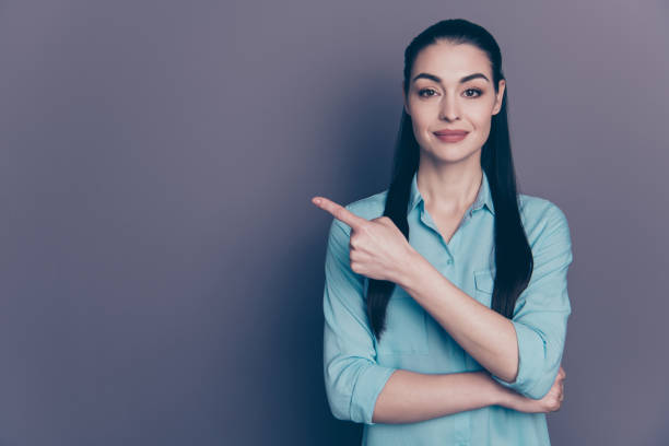 istock Photo of cheerful cute charming nice lecturer holding training teaching you pointing at empty space isolated over grey color background 1178339357