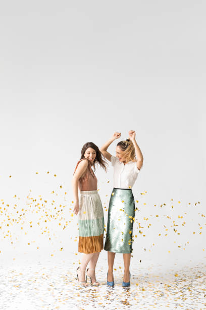 istock Party Girls Dancing Under Confetti 1178342869