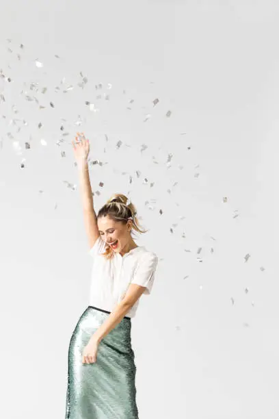 Photo of Happy Woman Dancing Under Confetti