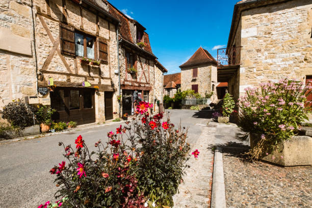 Autoire village, a Beaux Villages de France in the Dordogne region of France The centre of the small village of Autoire in the Dordogne region of France. A well preserved Beaux Village de France, it is most noted for a nearby waterfall, The Cascade. ancient villages stock pictures, royalty-free photos & images