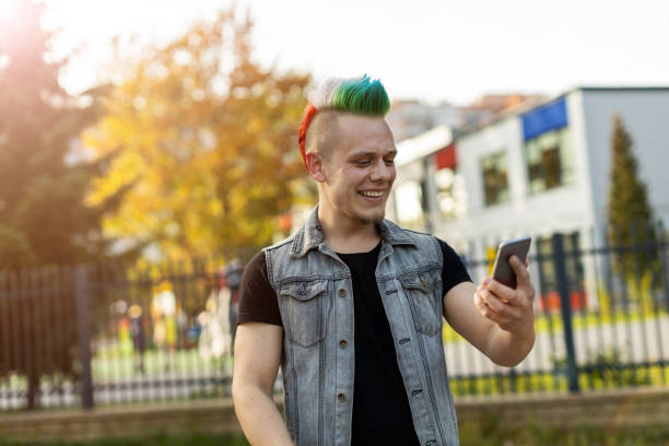 istock Young punk man with smart phone 1178343260