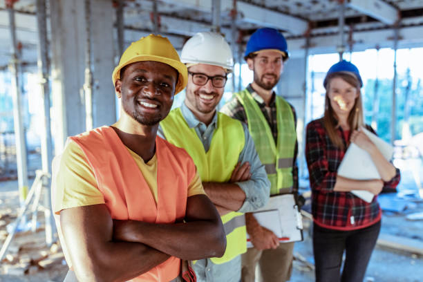 istock Portrait Of Builder On Building Site With Apprentices 1178343377