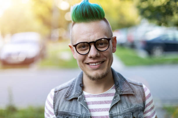 Portrait of a cool young man with pink mohawk Portrait of a cool young man with pink mohawk mohawk stock pictures, royalty-free photos & images