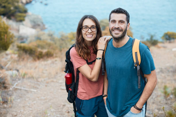 Young couple on a walk by the coastline. Lifestyle trekking and hiking in Catalonia's Costa Brava. cap de creus stock pictures, royalty-free photos & images