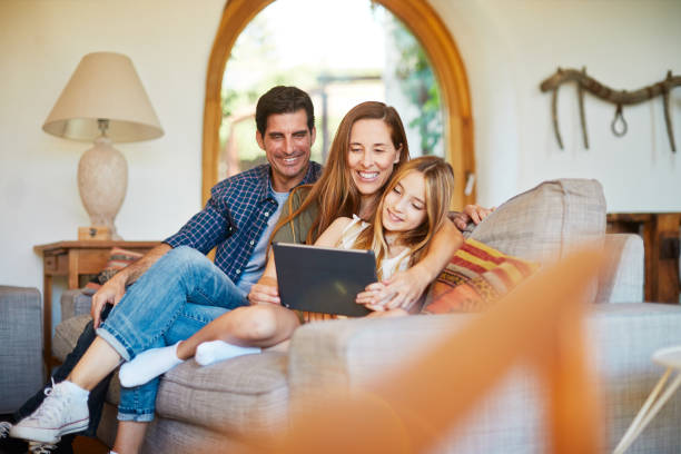 istock Daughter sharing a digital tablet with her parents. 1178343691