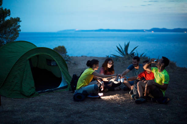 istock A group of friends camping and relaxing at twilight. 1178343692