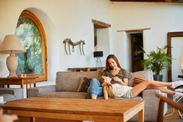 istock Mother and daughter at home relaxing on the sofa. 1178343733