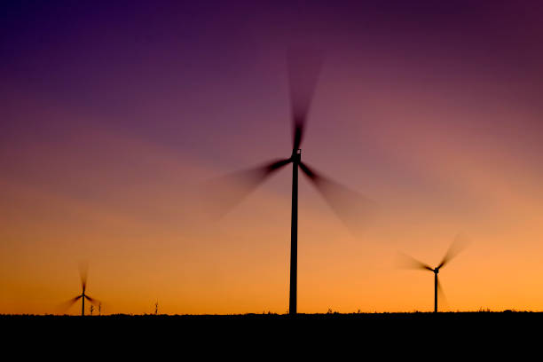 istock Windmill wind turbines spinning fast in wind at sunset or sunrise 1178344599