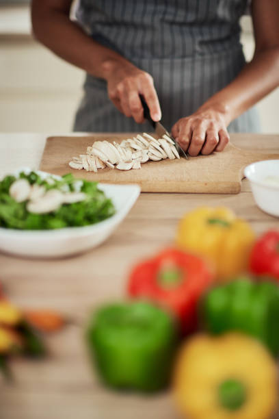 istock Woman cutting mushrooms. 1178344788