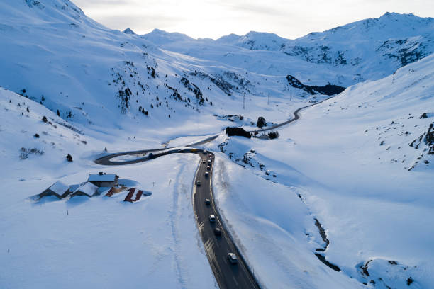 Winter Landscape with Mountain Road, Aerial View Aerial view of a winding mountain road, Julier Pass, Graubunden Canton, Switzerland. swiss alps photos stock pictures, royalty-free photos & images