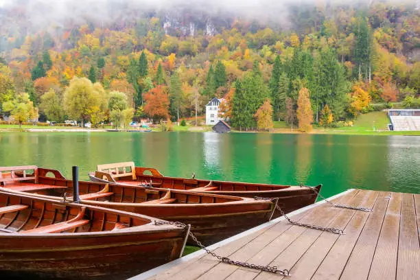 Photo of Autumn scenery with boats moored on Bled lake, Slovenia