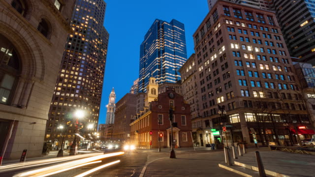 4K Time lapse of crowd people and traffic in front area of Boston old state house at the twilight time, Massachusetts, USA downtown skyline, Architecture and building with tourist concept.