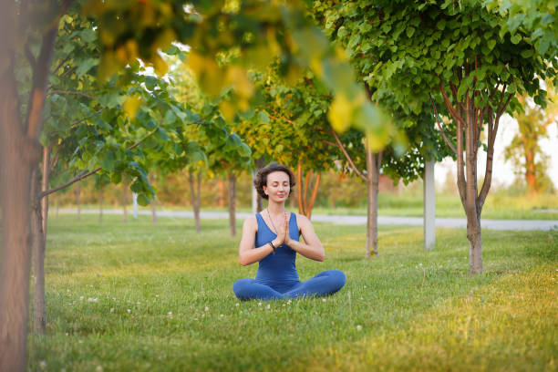 istock Yoga instructor in lotus position and meditating 1178348811