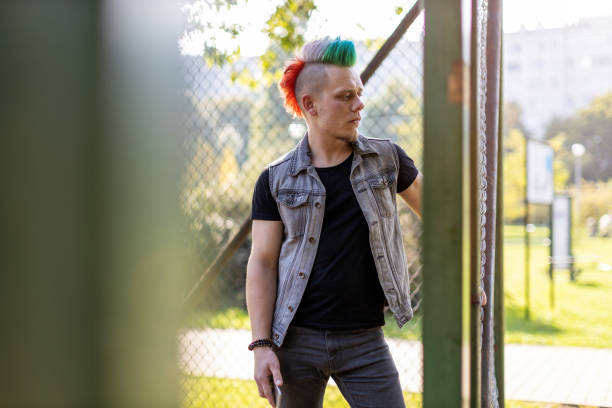 istock Portrait of a cool young man with pink mohawk 1178350610