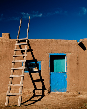 Taos, New Mexico / USA – November 6, 2011: Adobe structures have been built for centuries in the Southwest United States.