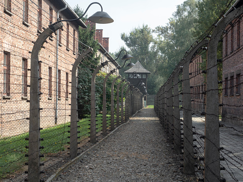 Oswiecim, Poland - 24th Sep 2019: Barbed wire fences, which would have been originally electrified, at Auschwitz-Birkenau concentration and extermination camp near Oswiecim in Poland.  Now an historical monument, it is estimated that the Nazis murdered over a million Jewish people, Polish people, Soviet POWs and other ethnic groups at the camp between 1940 and 1945.