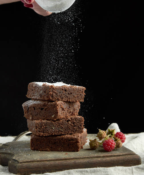 istock stack of square baked brownie chocolate cake slices sprinkled with white sugar from an iron sieve 1178353672
