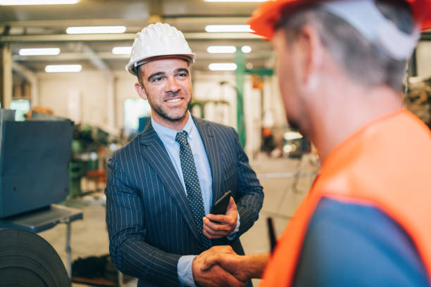 istock Manager in handshake with new worker in factory 1178353805